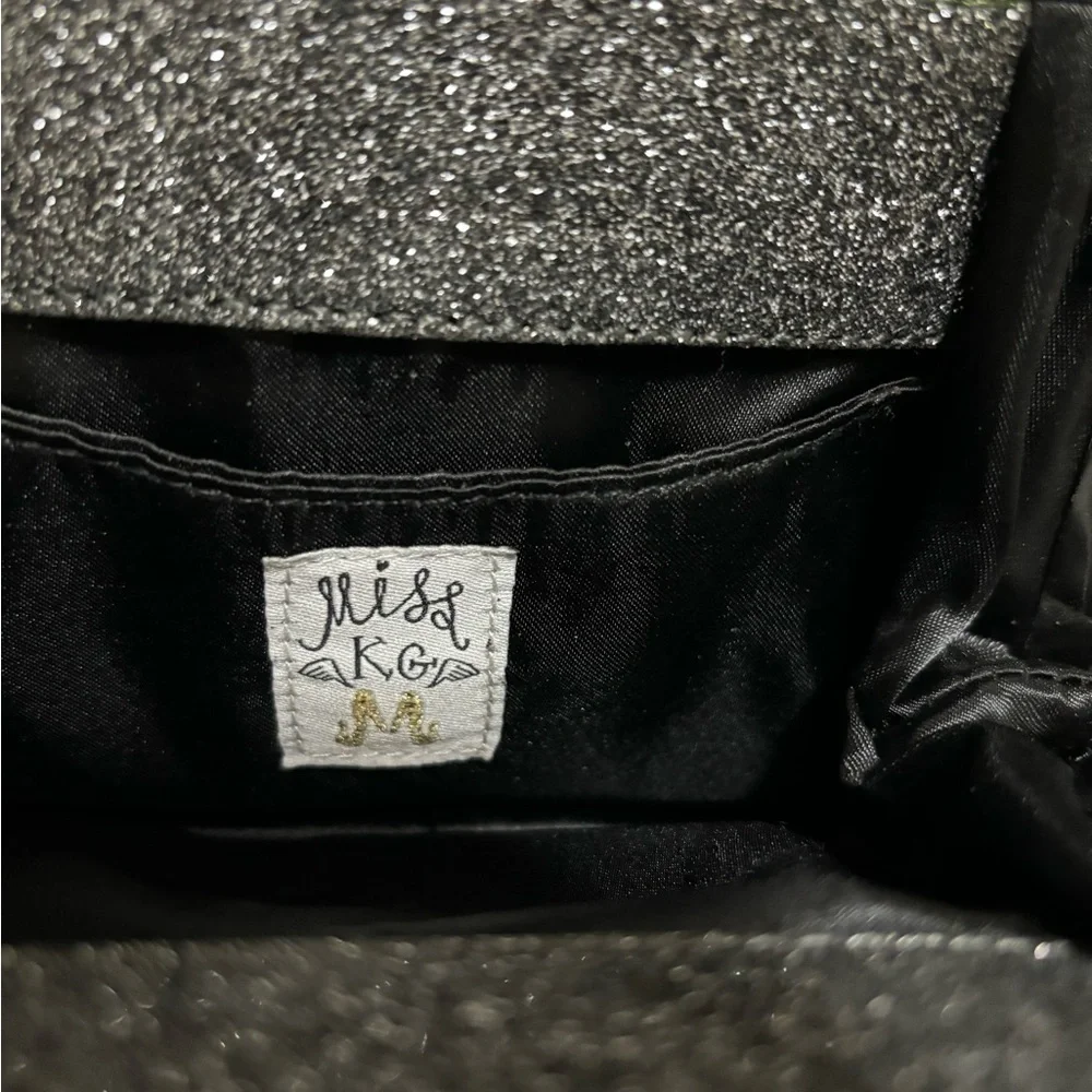 Miss KG Clutch with Chain Strap and a Bow Accent on the Front Silver